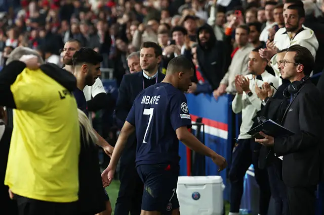 Kylian Mbappe (C) walks off the pitch