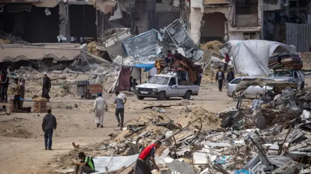 Internally displaced Palestinians, carrying their belongings, set up tents on the ruins of their homes after the Israeli army asked them to evacuate from the city of Rafah, in Khan Yunis camp, southern Gaza Strip, 07 May 2024