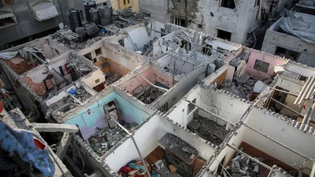 Houses damaged in an Israeli strike are seen, amid the ongoing conflict between Israel and the Palestinian Islamist group Hamas, in Rafah