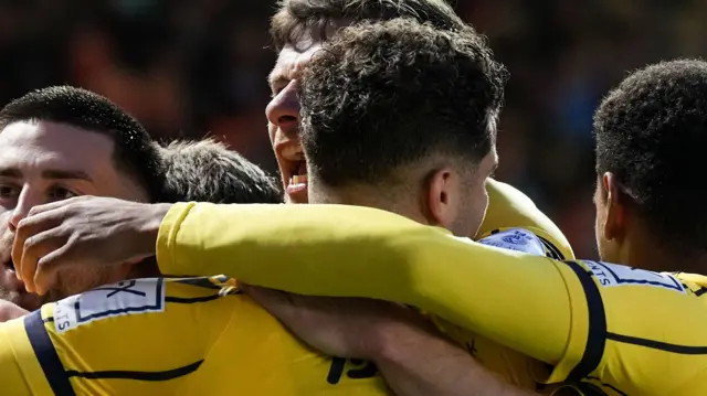 Oxford United players celebrate scoring