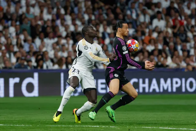 Mendy and Sane battle for the ball