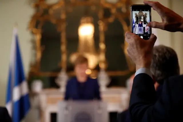 A picture is taken of Nicola Sturgeon using a camera phone in the Bute House drawing room