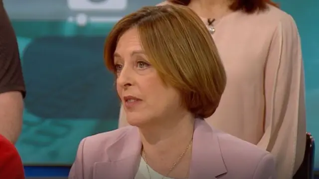 Dawes, in a pink blazer, sits among parents in the Breakfast studio