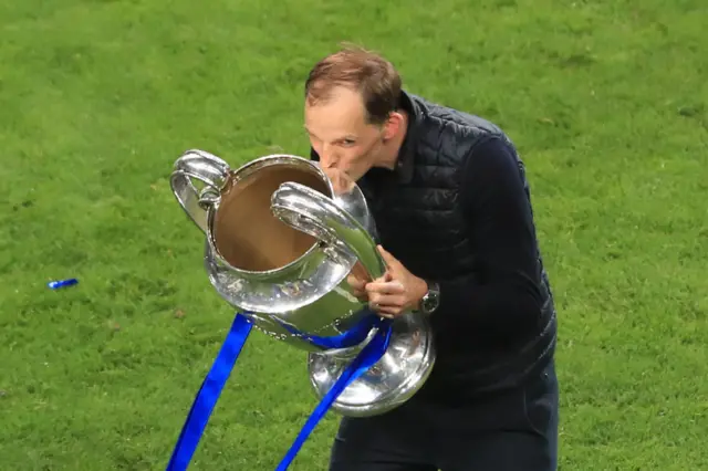 Tuchel holds and kisses the UCL trophy