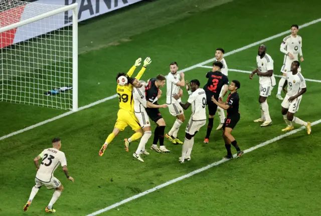 Mile Svilar of AS Roma misplaces a catch which results in an own-goal from Gianluca Mancini of AS Roma during the UEFA Europa League 2023/24 Semi-Final second leg match between Bayer 04 Leverkusen and AS Roma at BayArena on May 09, 2024 in Leverkusen, Germany.