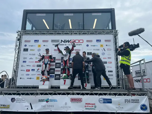 Glenn Irwin celebrates on the podium