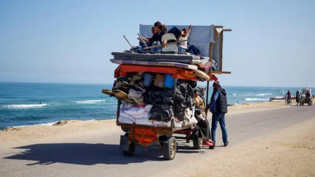 Palestinians travel in an animal-drawn cart as they flee Rafah after Israeli forces launched a ground and air operation in the eastern part of the southern Gaza city on Thursday