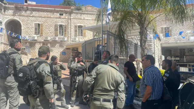 Israel police stand near the Al Jazeera office in Nazareth