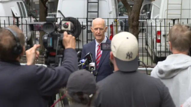 Rick Scott talking to the media