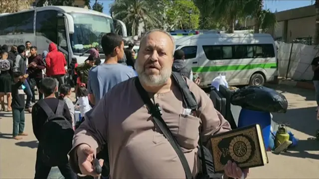 A man stands in a field hospital and speaks to the BBC about his experience fleeing Rafah