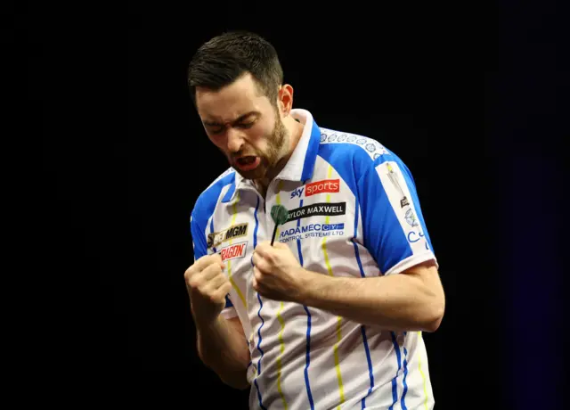 Luke Humphries celebrates beating Rob Cross