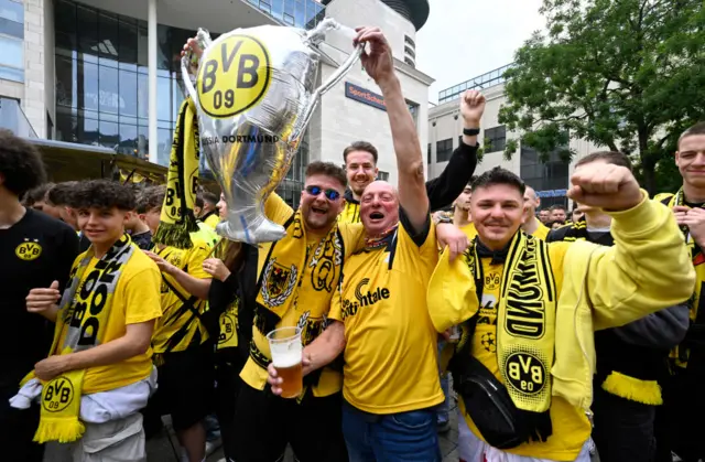 Dortmund fans hold up an inflatable UCL trophy