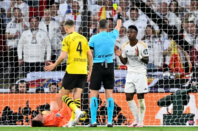 Vinicius is shown a yelow card after a foul on Kobel