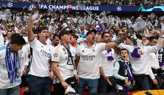 Madrid fans chant the club anthem in the stands