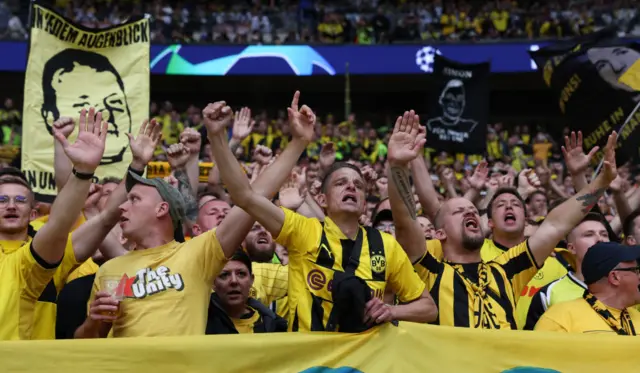 Dortmund fans chant their club anthem in the stands