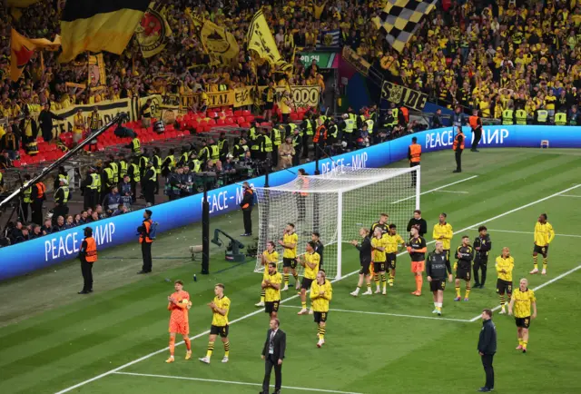 Dortmund players applaud the fans at full time