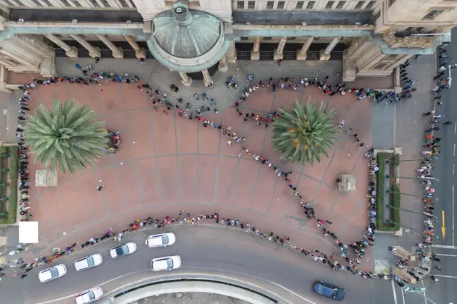 This aerial view shows voters waiting in line outside the Johannesburg City Hall polling station in Johannesburg's Central Business District, on 29 May 2024, during South Africa's general election.