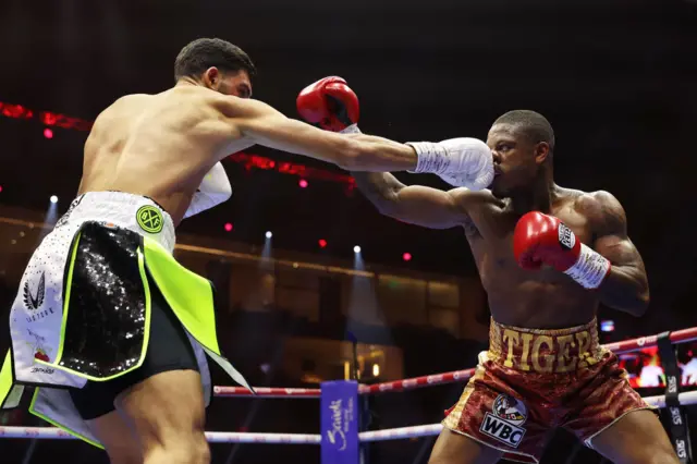 Hamzah Sheeraz and Austin Williams throw punches