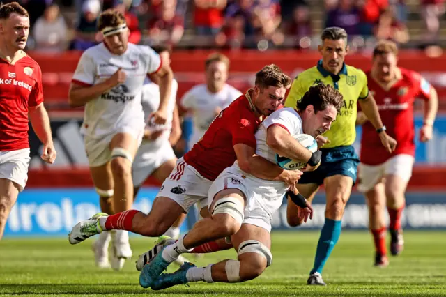 Munster's Jack Crowley tackles David McCann