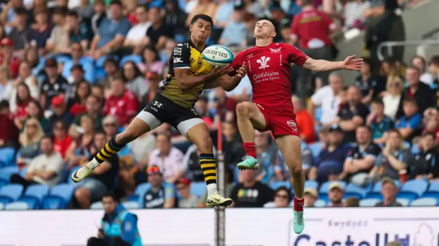 Rio Dyer of Dragons wins the ball as he competes with Ioan Nicholas of Scarlets