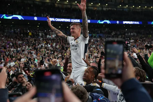 kroos is lifted into the air by the madrid fans