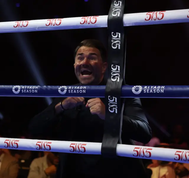 Eddie Hearn on his feet at the side of the ring