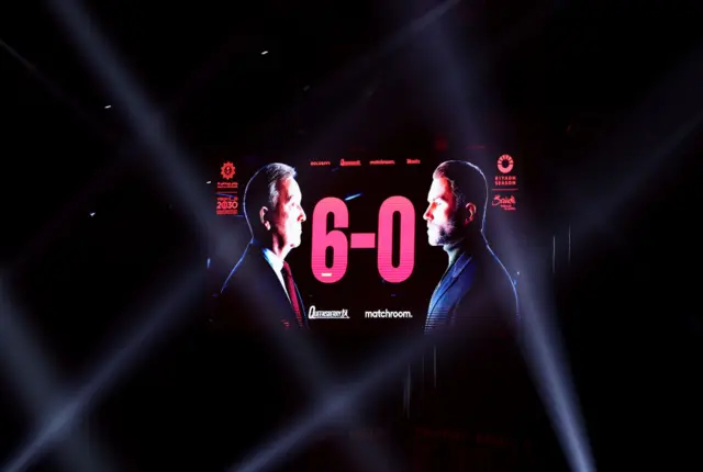 Screen showing Eddie Hearn and Frank Warren next to a 6-0 scoreline