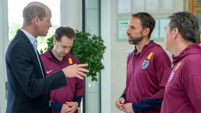 The Prince of Wales (left) speaks with England manager Gareth Southgate (second from right) during a visit to St George's Park, in Burton upon Trent, Staffordshire, to meet with the England men's football team ahead of the UEFA Euro 2024 campaign.