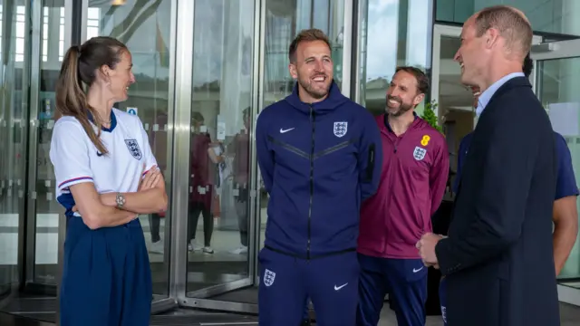 The Prince of Wales (right) speaks with Jill Scott (left), Harry Kane (centre) and Gareth Southgate (second from right) during a visit to St George's Park, in Burton upon Trent, Staffordshire, to meet with the England men's football team ahead of the UEFA Euro 2024 campaign.