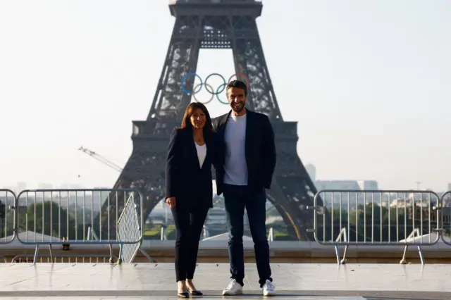 Mayor of Paris Anne Hidalgo and Tony Estanguet, president of the Paris 2024 Olympics organising committee in front of the Eiffel Tower and Olympics rings