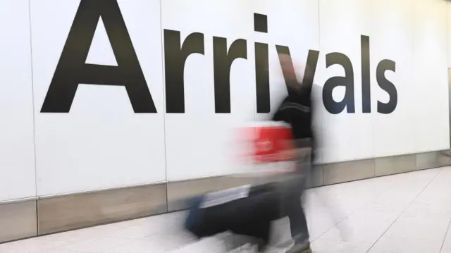 Passenger at Heathrow Airport arrivals hall