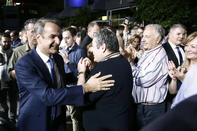 Prime Minister Kyriakos Mitsotakis meets supporters on Sunday night