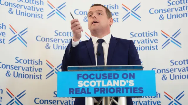 Douglas Ross points as he speaks