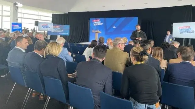 People gather in chairs for the manifesto launch