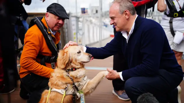 Lib Dem leader Ed Davey pets a dog