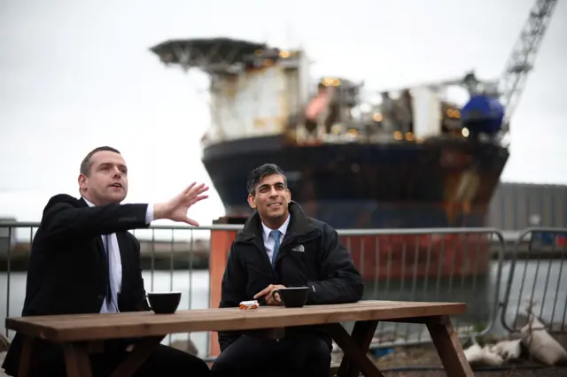 Douglas Fraser and Rishi Sunak share hot drinnks at the Port of Nigg.