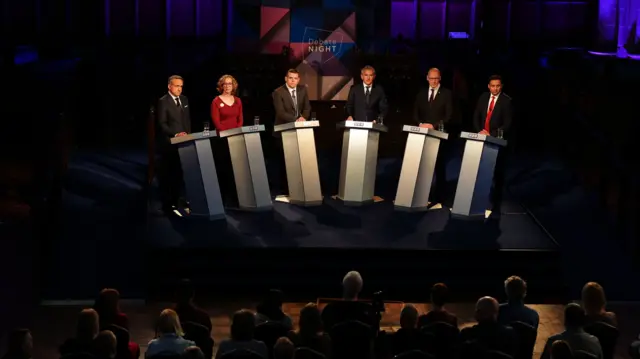 Scottish political leaders stand at podiums during a debate