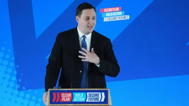 Ben Houchen is seen standing in front of a Conservative podium with the words: Clear Plan, Bold Action and Secure Future written across it.