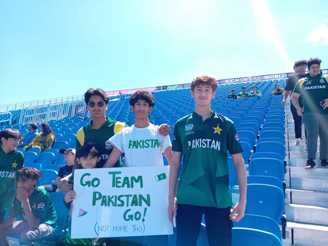 Three Pakistan fans hold up a 'go Pakistan' sign