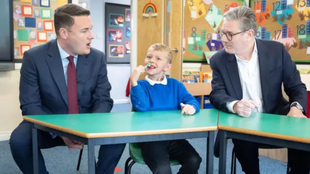 Labour leader Keir Starmer, shadow health secretary Wes Streeting, and a pupil (with toothbrush) from Whale Hill Primary School in Middlesbrough earlier today