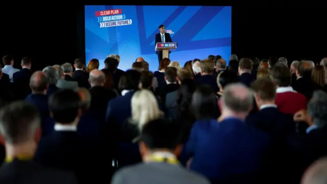 Rishi Sunak answers questions from the media while standing at a podium unveiling the Conservative manifesto