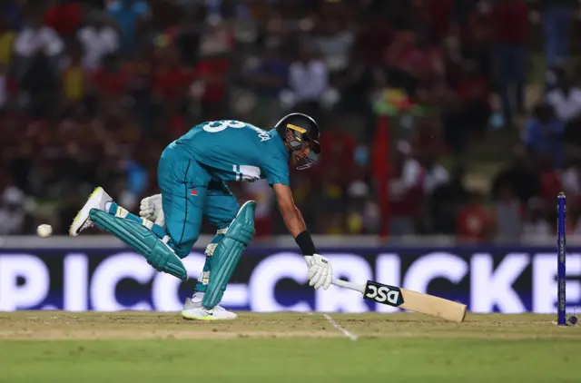 Rachin Ravindra slides to make his ground