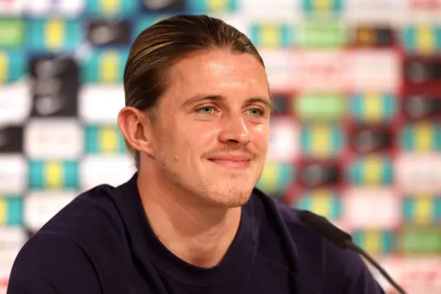 Conor Gallagher confidently listens to a reporter during a media conference