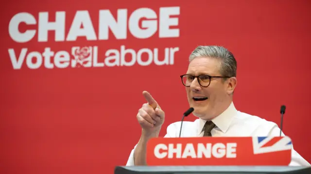 Starmer stands at a lectern with the word 'change' on it