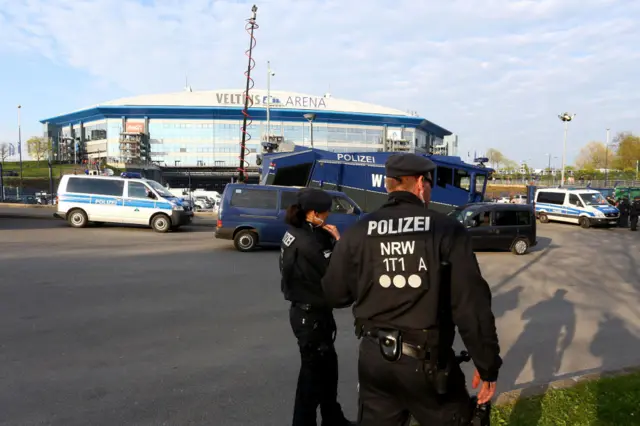 Police stand beside vehicles outside of Schalke's Arena AufSchalke