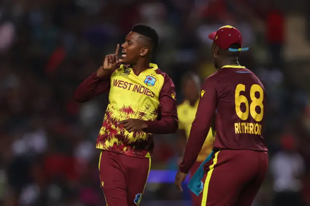 Akeal Hosein celebrates the wicket of Devon Conway