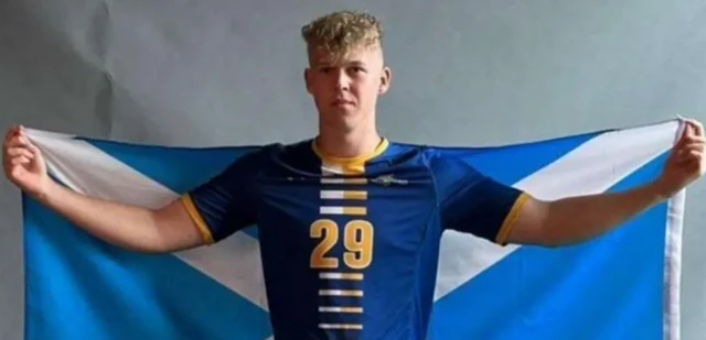 Teenage footballer Ethan Walker holding a Scotland flag