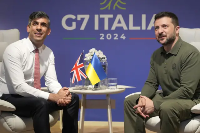 Ukrainian President Volodymyr Zelensky and UK Prime Minister Rishi Sunak talk at the G7 Summit in Italy