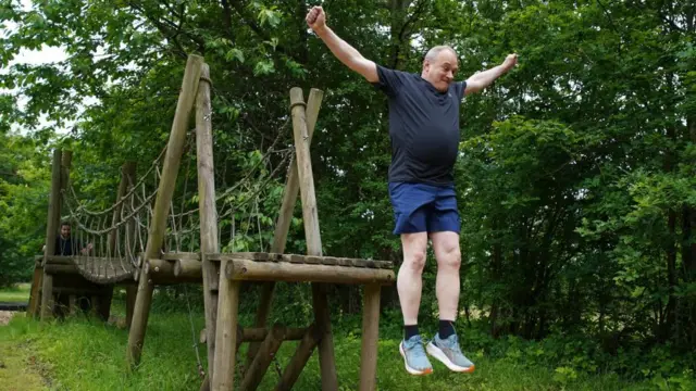 Liberal Democrats leader Sir Ed Davey on an assault course during a visit to Arena Pursuits in Wadhurst