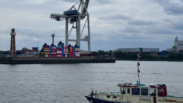 Hamburg harbourfront showing shipping containers painted with flags of nations competing at Euro 2024